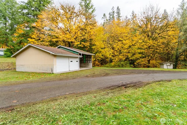 a view of backyard of house with trees