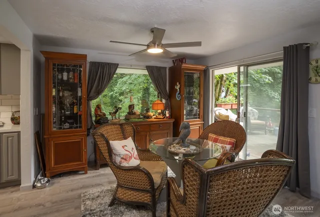 a living room with furniture and a floor to ceiling window