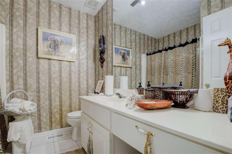 4270 Berkeley Mill Lane Duluth, GA 30096 - Photo 11 of 28 a bathroom with a sink a toilet and shower curtain