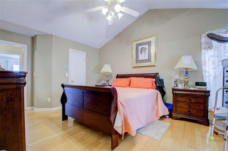 4270 Berkeley Mill Lane Duluth, GA 30096 - Photo 15 of 28 a bedroom with bed and a chandelier