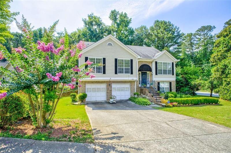 4270 Berkeley Mill Lane Duluth, GA 30096 - Photo 2 of 28 a front view of a house with a yard and potted plants