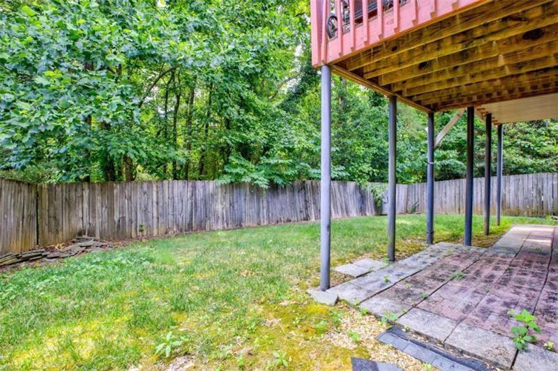4270 Berkeley Mill Lane Duluth, GA 30096 - Photo 27 of 28 a view of a backyard with a swing plants and wooden fence