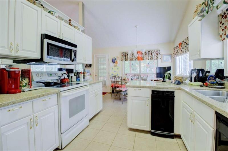 4270 Berkeley Mill Lane Duluth, GA 30096 - Photo 10 of 28 a kitchen with stainless steel appliances granite countertop a sink and cabinets