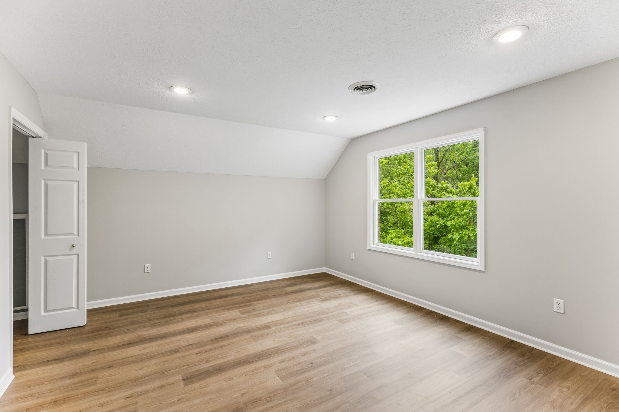 831 Defeated Creek Road Centerville, TN 37033 - Photo 12 of 26 an empty room with wooden floor and windows