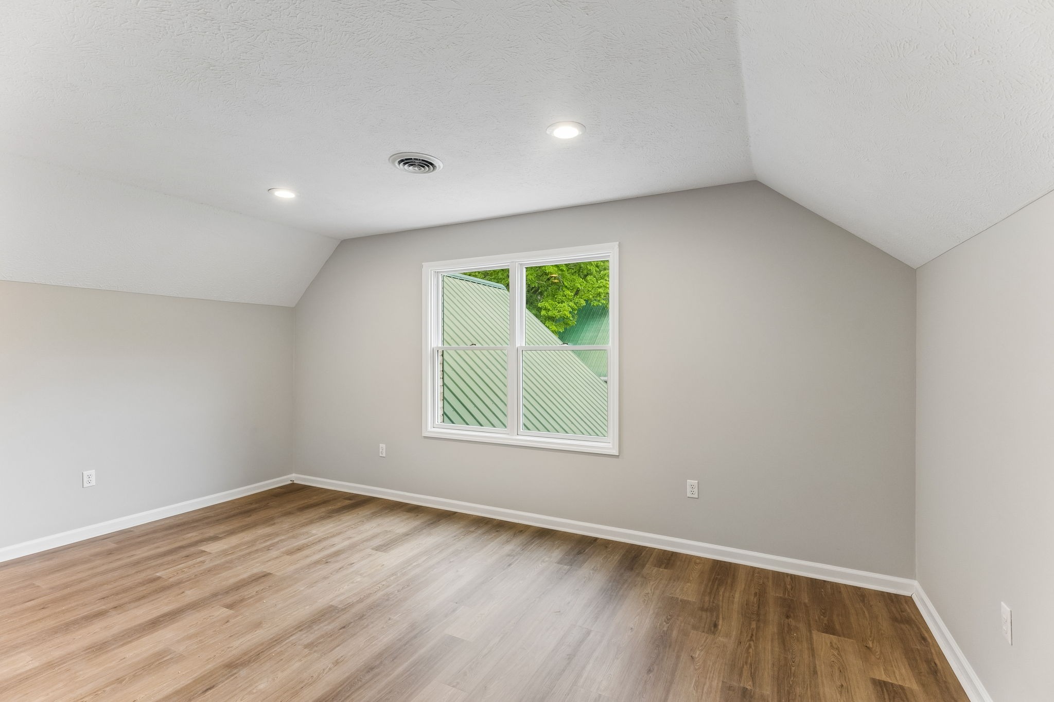 831 Defeated Creek Road Centerville, TN 37033 - Photo 13 of 26 an empty room with wooden floor and a window