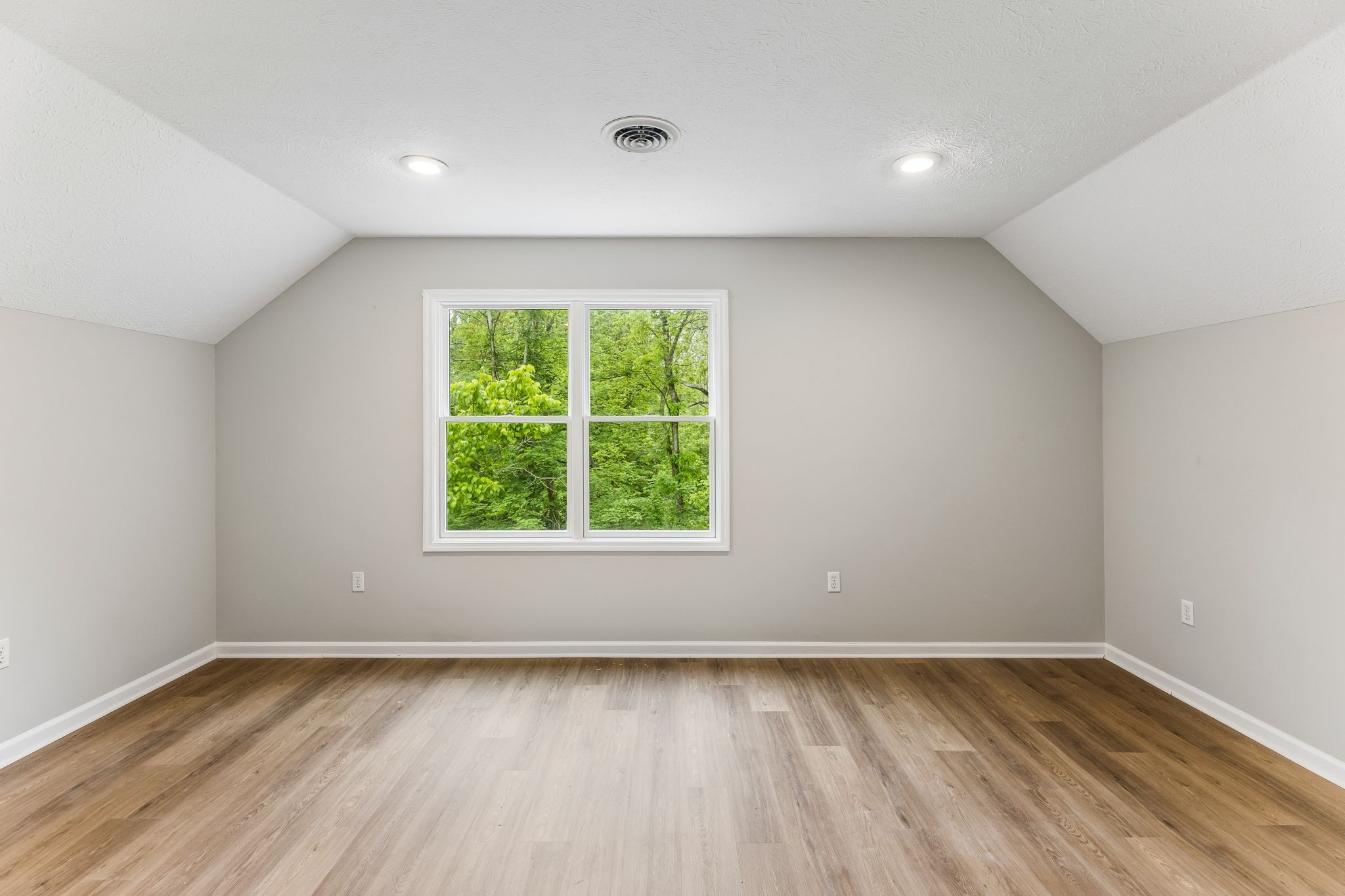 831 Defeated Creek Road Centerville, TN 37033 - Photo 17 of 26 a view of an empty room with wooden floor and a window