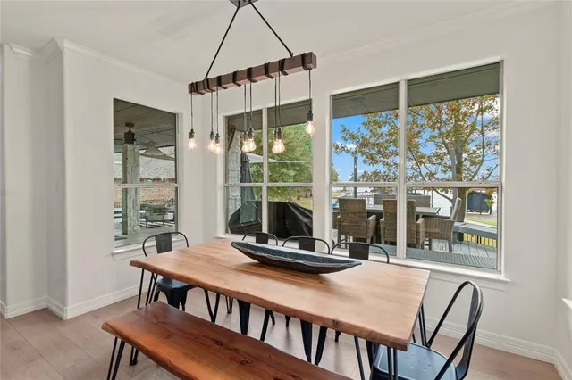 a dining room with a table and chairs