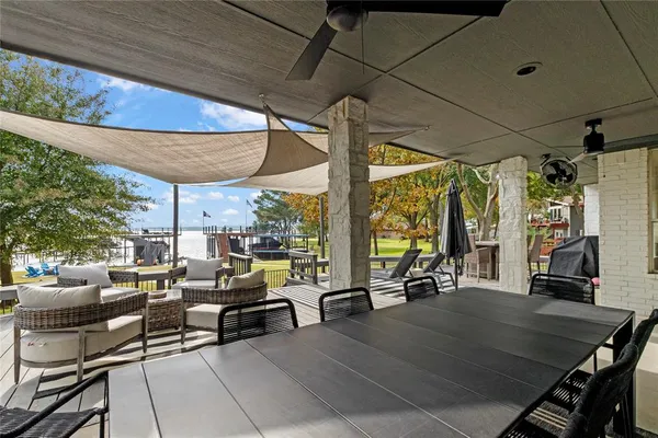 a view of a patio with couches table and chairs and potted plants