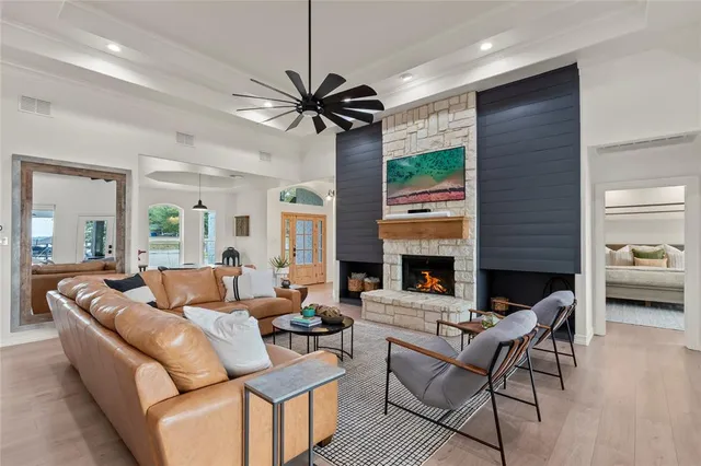 a living room with fireplace furniture and a large window