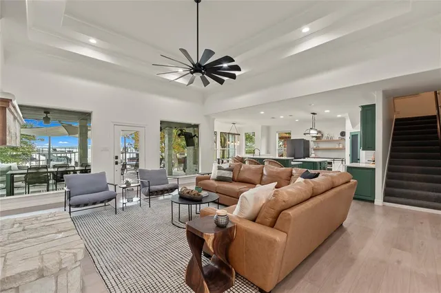 a living room with furniture a ceiling fan and a rug