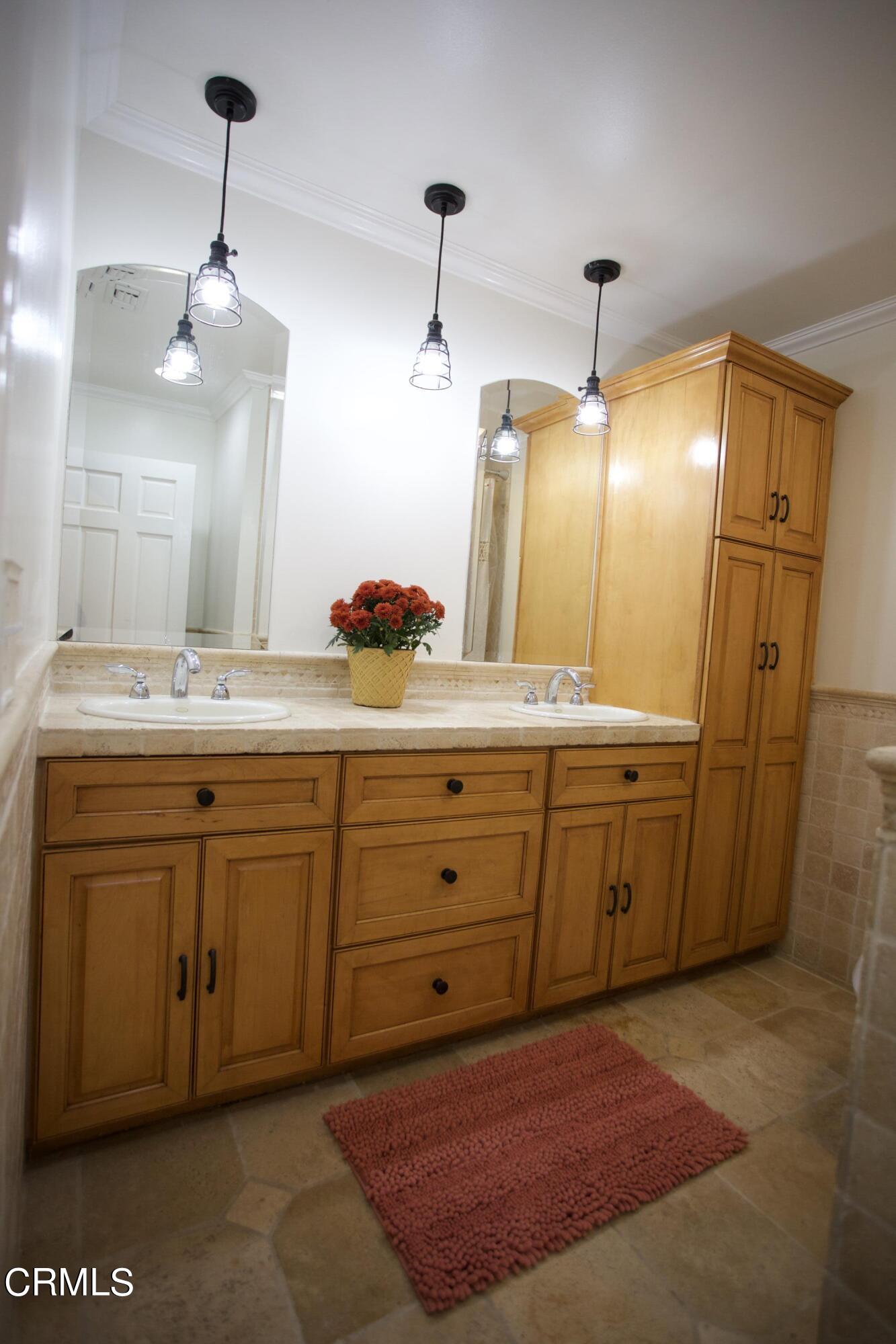 7438 Alpine Way Tujunga, CA 91042 - Photo 13 of 30 a spacious bathroom with a granite countertop sink and a mirror