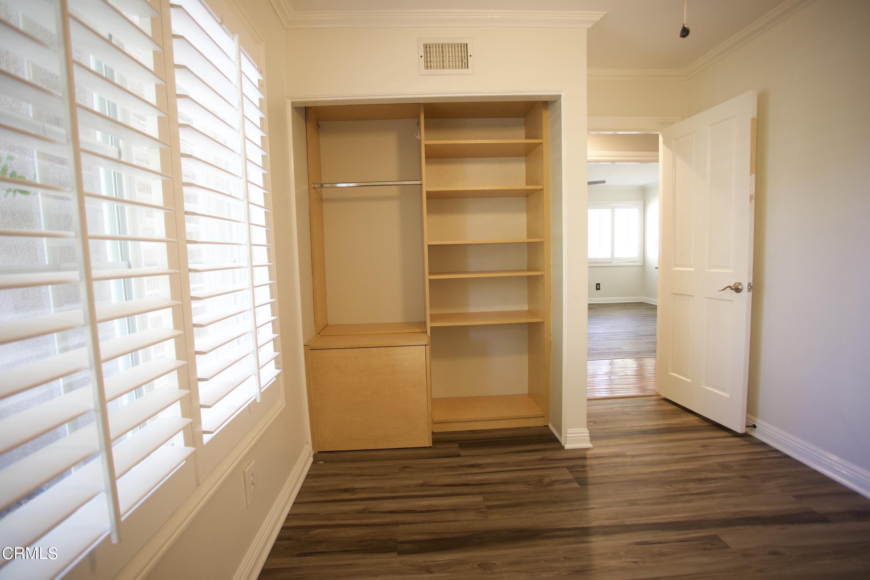 7438 Alpine Way Tujunga, CA 91042 - Photo 14 of 30 a view of an empty room with wooden floor and a window