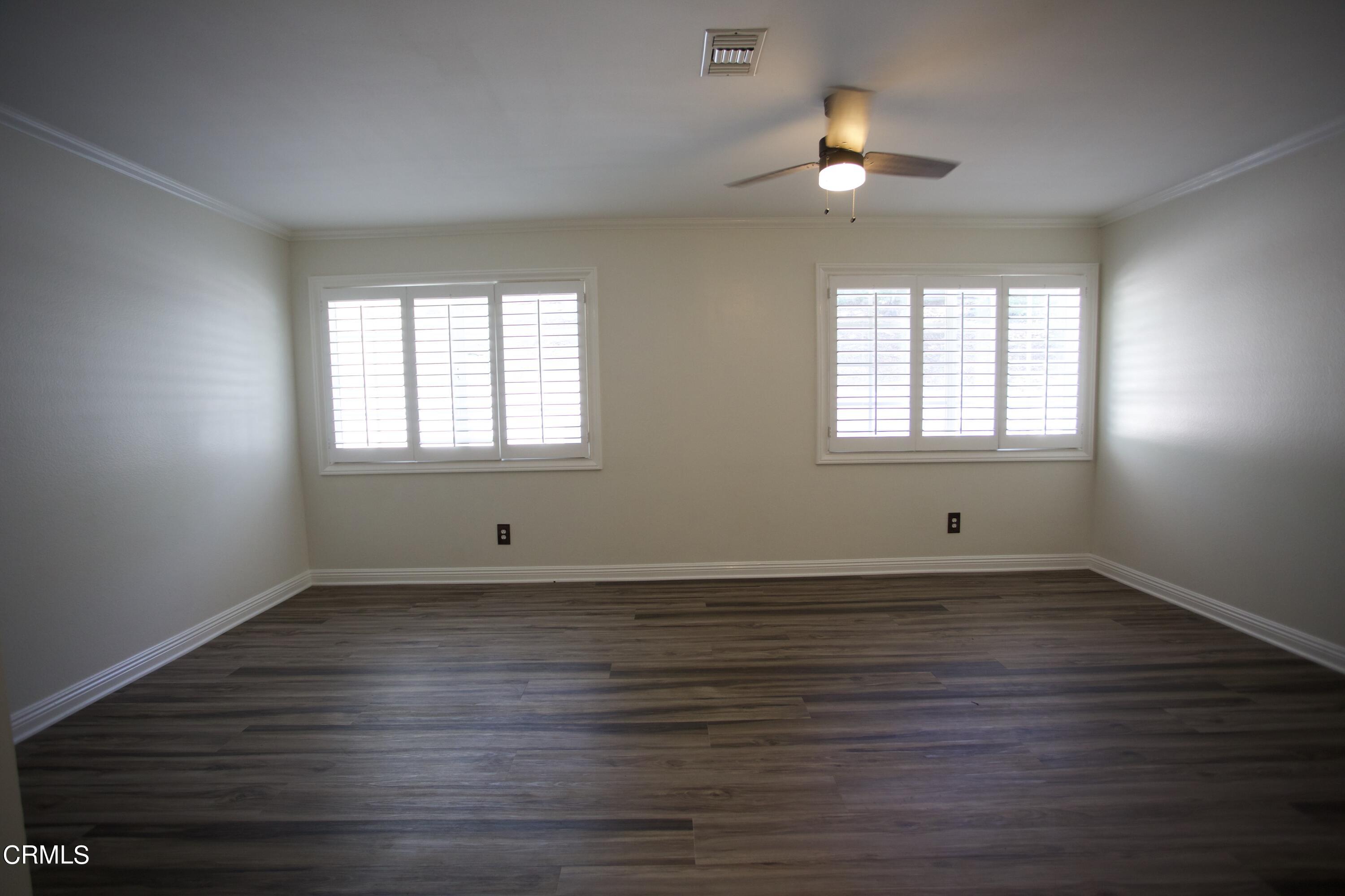 7438 Alpine Way Tujunga, CA 91042 - Photo 16 of 30 an empty room with wooden floor and windows