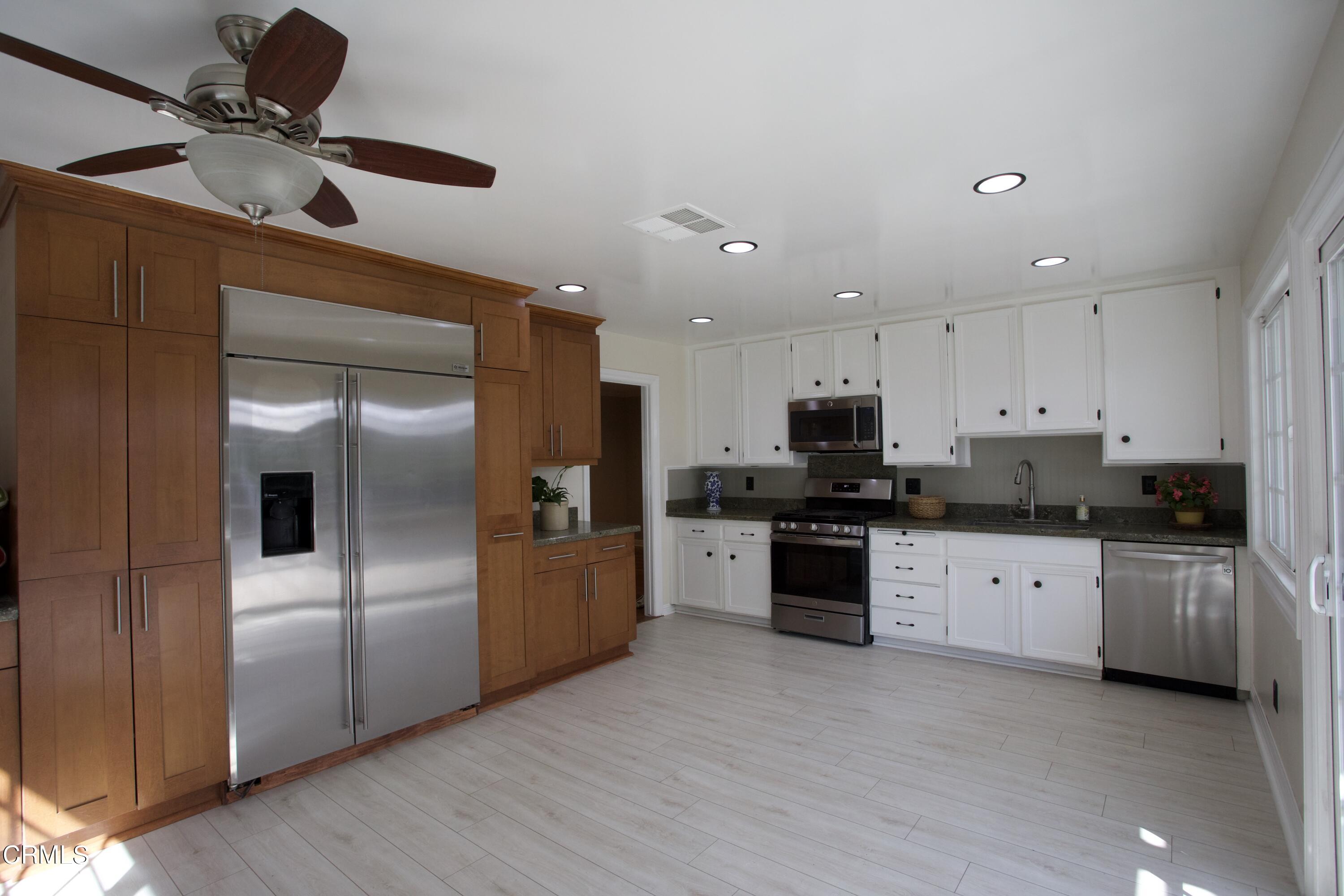7438 Alpine Way Tujunga, CA 91042 - Photo 20 of 30 a kitchen with stainless steel appliances granite countertop a refrigerator a stove and a sink