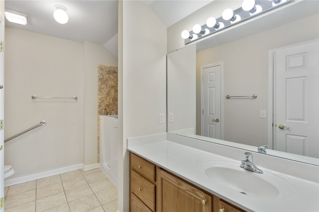155 Life Style Lane Anderson, SC 29621 - Photo 29 of 49 This bathroom features a single vanity, a large mirror, and tiled flooring.