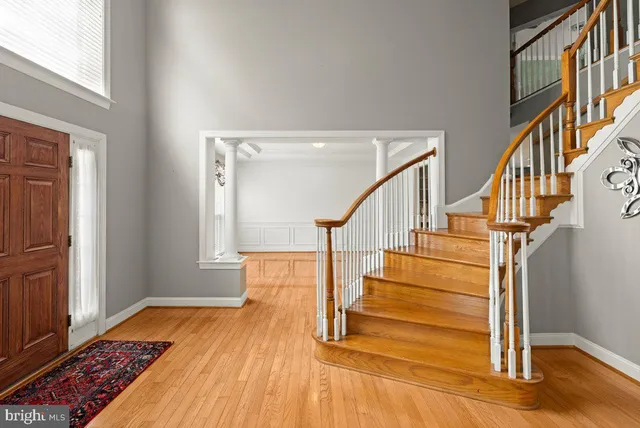 a view of entryway and hall with wooden floor