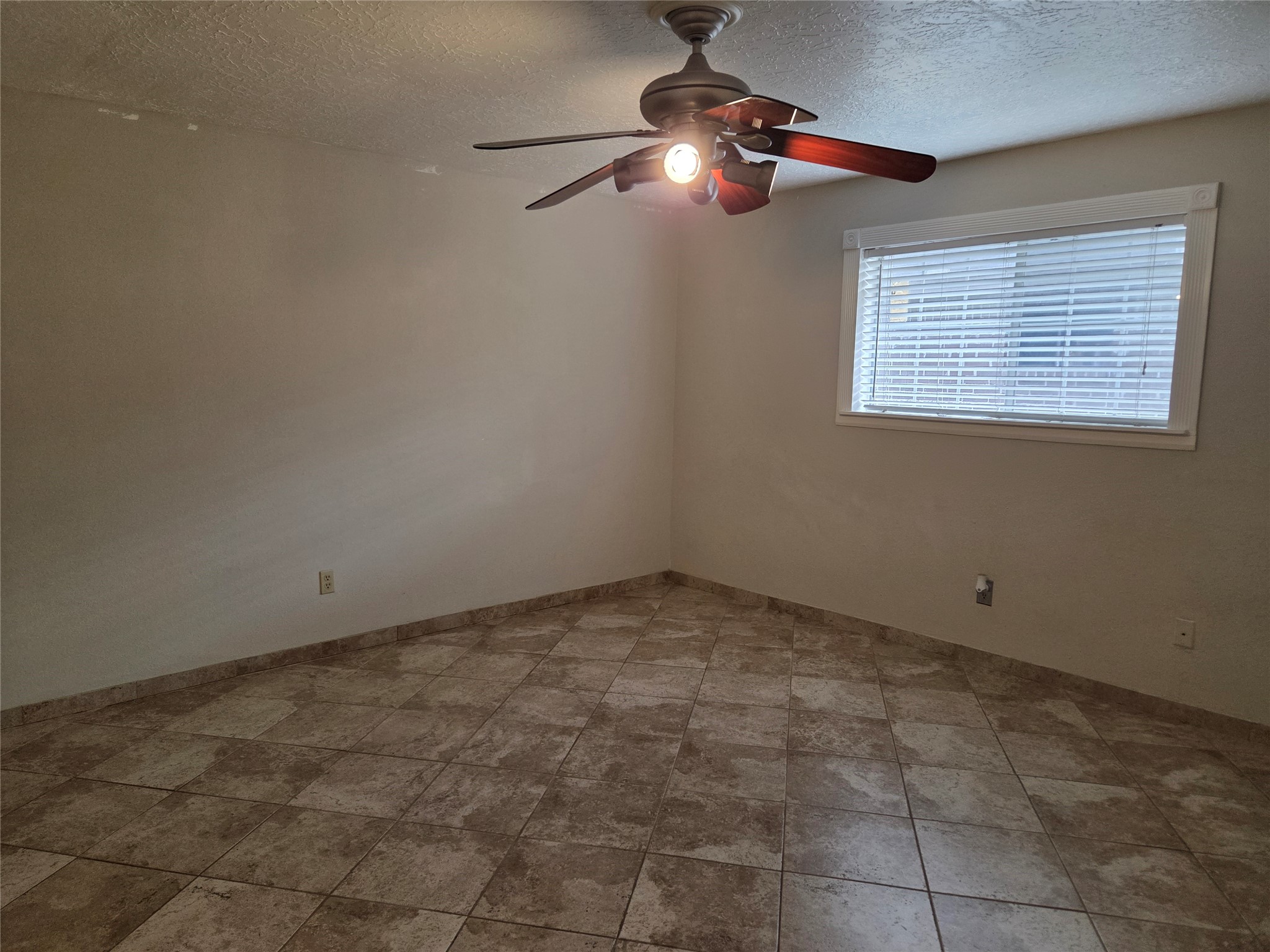 15415 Beechnut Street Houston, TX 77083 - Photo 15 of 28 a view of an empty room with a window