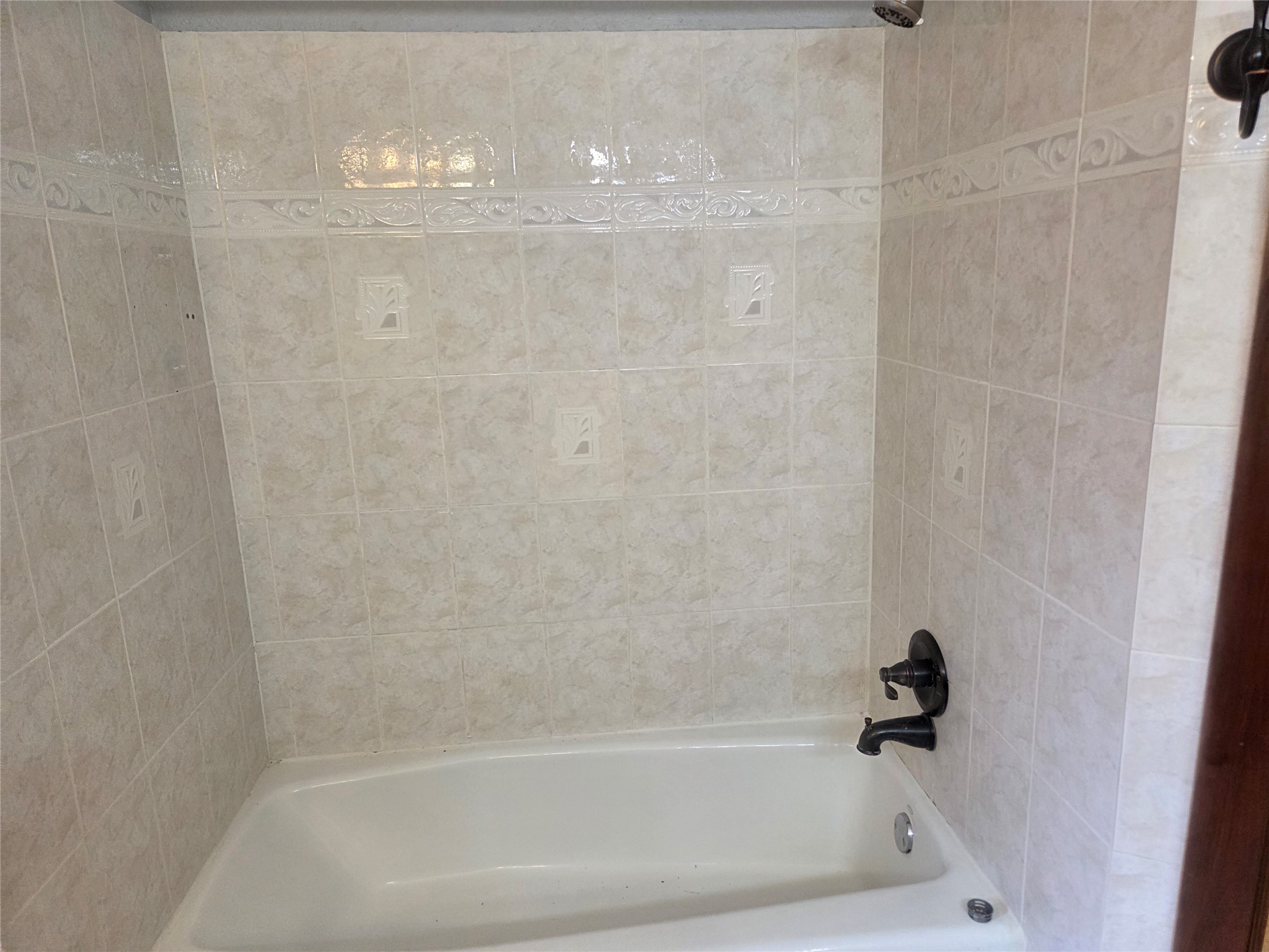 15415 Beechnut Street Houston, TX 77083 - Photo 19 of 28 a close up of a bathtub in a bathroom