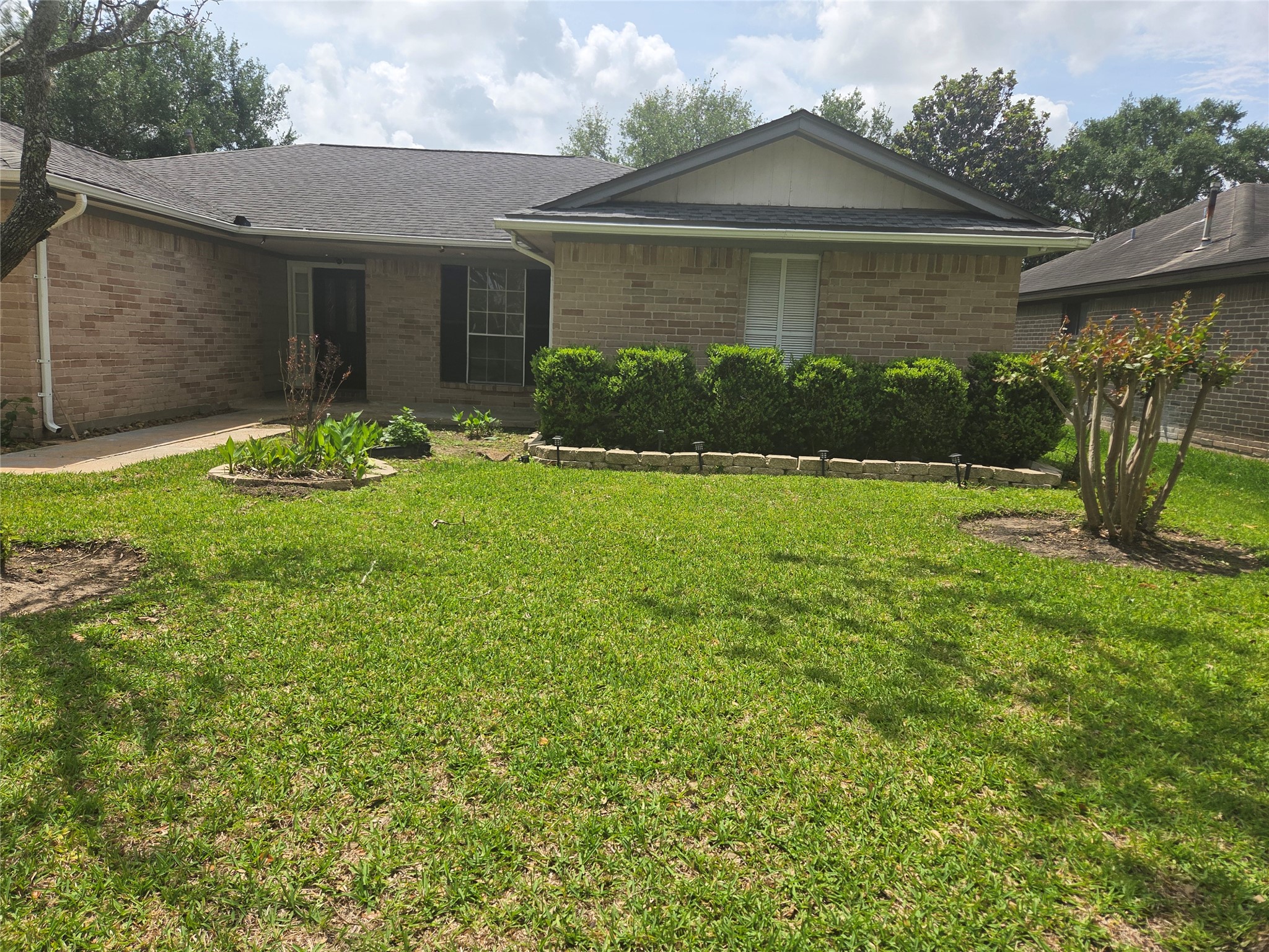 15415 Beechnut Street Houston, TX 77083 - Photo 26 of 28 a front view of a house with garden