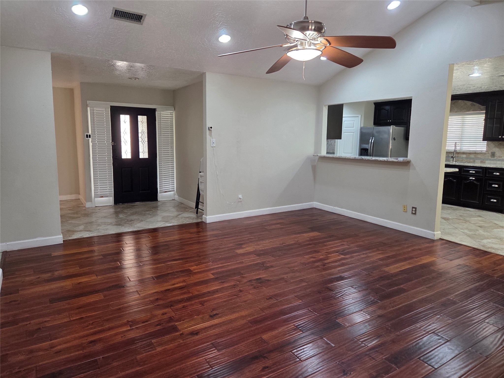 15415 Beechnut Street Houston, TX 77083 - Photo 3 of 28 a view of a livingroom with wooden floor and a ceiling fan