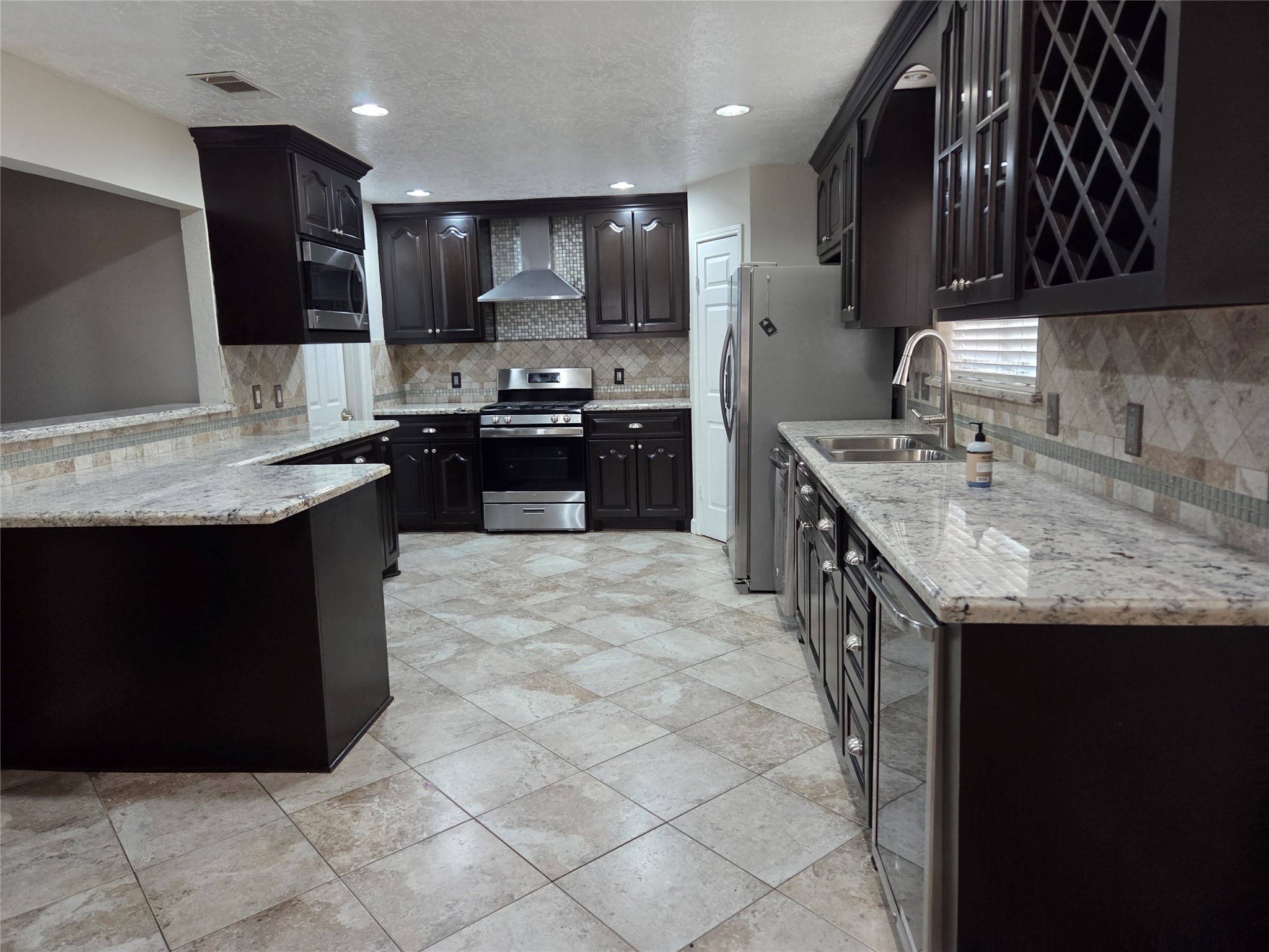 15415 Beechnut Street Houston, TX 77083 - Photo 5 of 28 a kitchen with kitchen island granite countertop a sink counter top space appliances and cabinets