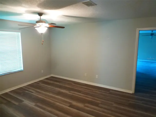 a view of a small space with wooden floor and a window