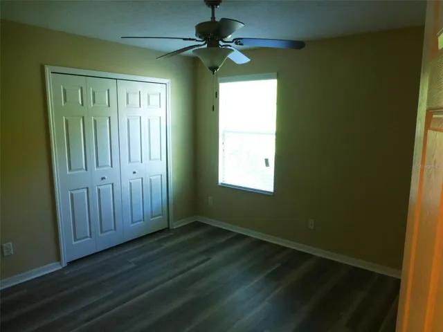 a view of an entryway with a chandelier fan