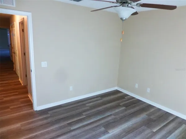 a view of a small space with wooden floor and a chandelier