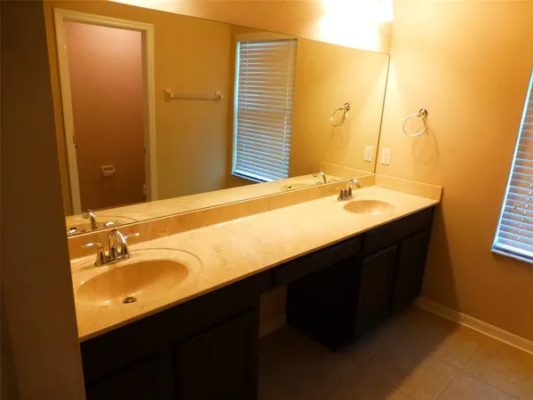 a bathroom with a double vanity sink and mirror