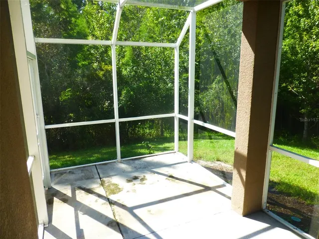 a view of a wooden deck with a backyard