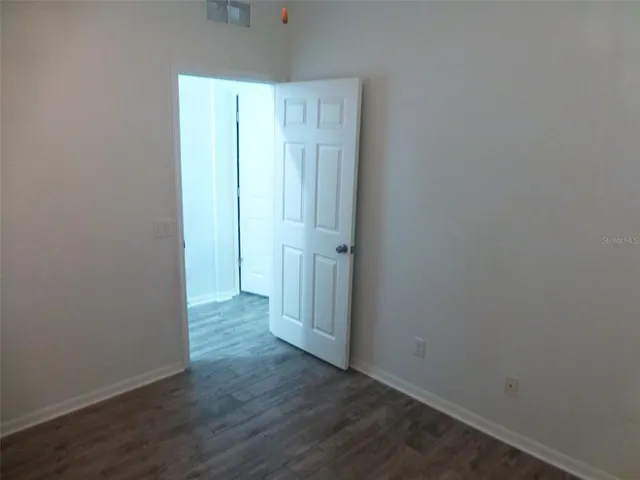 an empty room with wooden floor