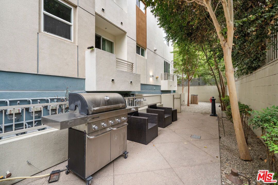 436 South Virgil Avenue, Unit 407 Los Angeles, CA 90020 - Photo 13 of 16 a kitchen with stainless steel appliances granite countertop a stove a sink and a microwave