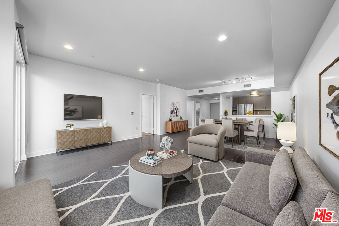 436 South Virgil Avenue, Unit 407 Los Angeles, CA 90020 - Photo 2 of 16 a living room with furniture and a flat screen tv