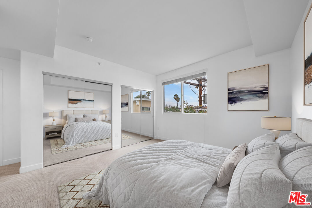 436 South Virgil Avenue, Unit 407 Los Angeles, CA 90020 - Photo 3 of 16 a bedroom with a large bed and a couch