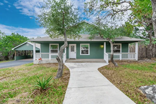 a front view of house with yard and green space