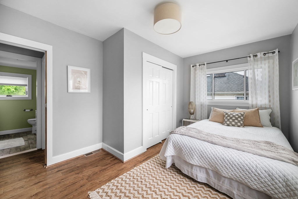 8 Baker Avenue Beverly, MA 01915 - Photo 20 of 40 a bedroom with a bed and a mirror