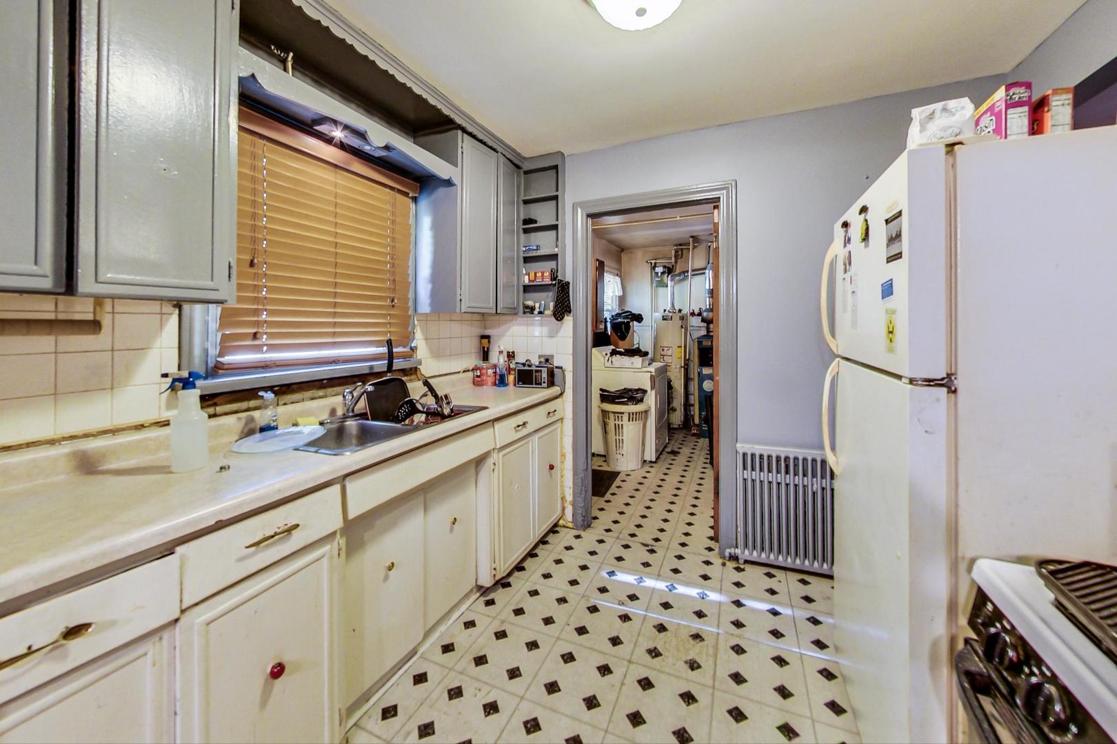 15545 Ridgeway Avenue Markham, IL 60428 - Photo 11 of 28 a kitchen with a sink a refrigerator and cabinets