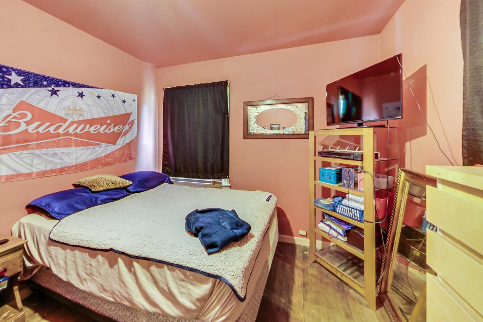 15545 Ridgeway Avenue Markham, IL 60428 - Photo 13 of 28 a bedroom with a bed furniture and a flat screen tv