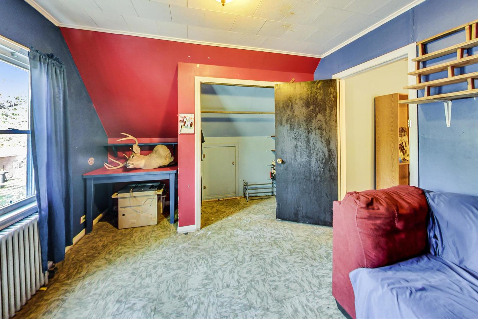 15545 Ridgeway Avenue Markham, IL 60428 - Photo 19 of 28 a bedroom with a bed and a fireplace