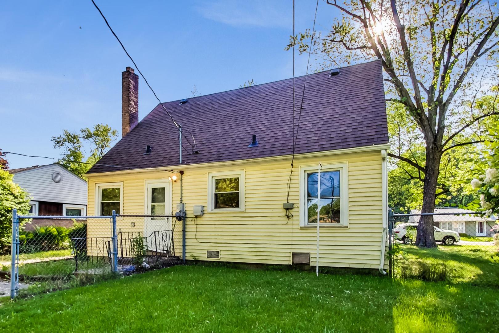 15545 Ridgeway Avenue Markham, IL 60428 - Photo 23 of 28 a view of a house with a yard and a large tree