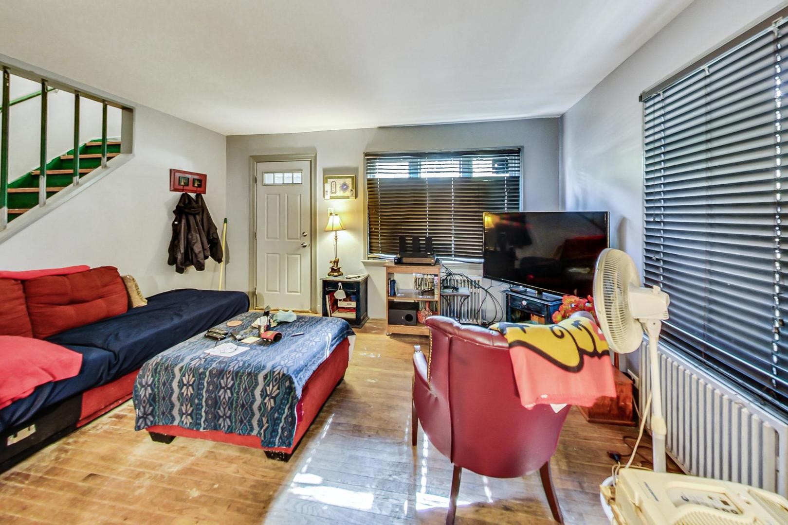 15545 Ridgeway Avenue Markham, IL 60428 - Photo 4 of 28 a bedroom with furniture and a flat screen tv