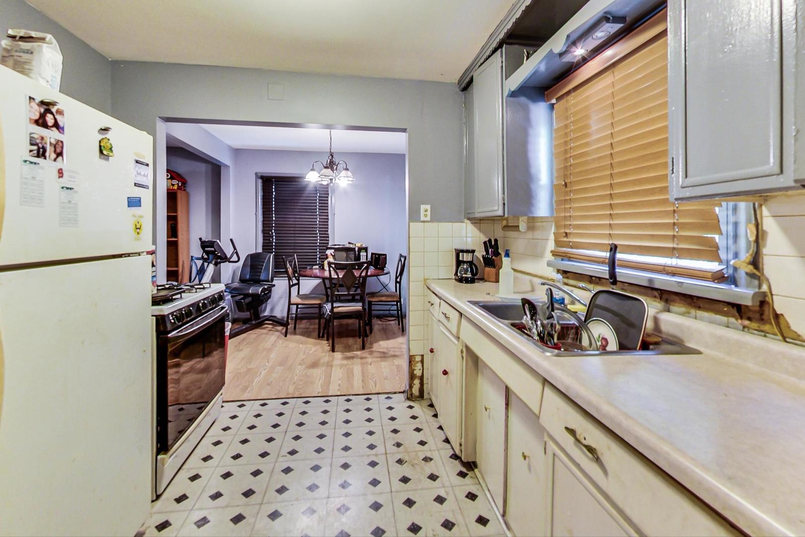 15545 Ridgeway Avenue Markham, IL 60428 - Photo 9 of 28 a kitchen with a sink a refrigerator and cabinets