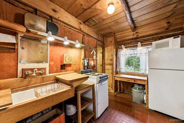 a kitchen with a stove a sink and a refrigerator