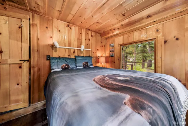 a bed sitting in a room next to a window