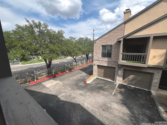 a view of a porch with wooden floor and fence