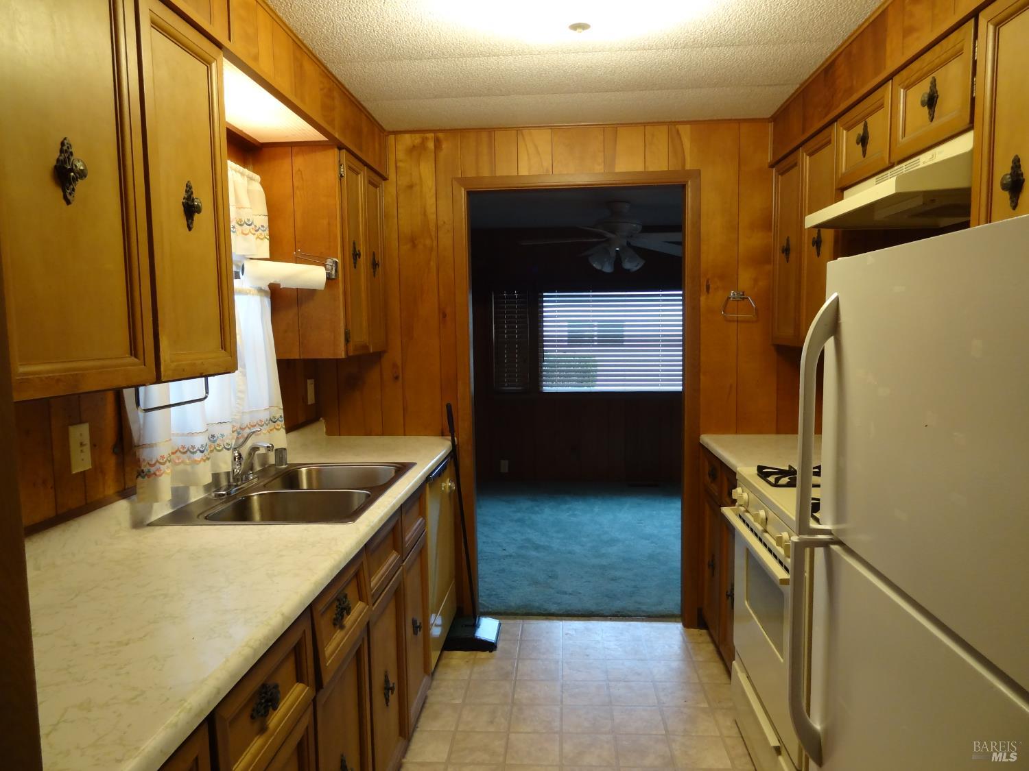 23 Tiffany Place, Unit 23 Santa Rosa, CA 95409 - Photo 6 of 6 a kitchen with a sink and a refrigerator