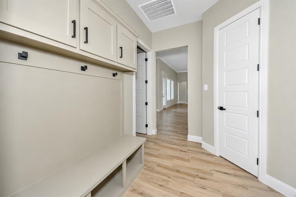 1057 Vh Ranch Poolville, TX 76487 - Photo 29 of 38 a view of a hallway with wooden floor
