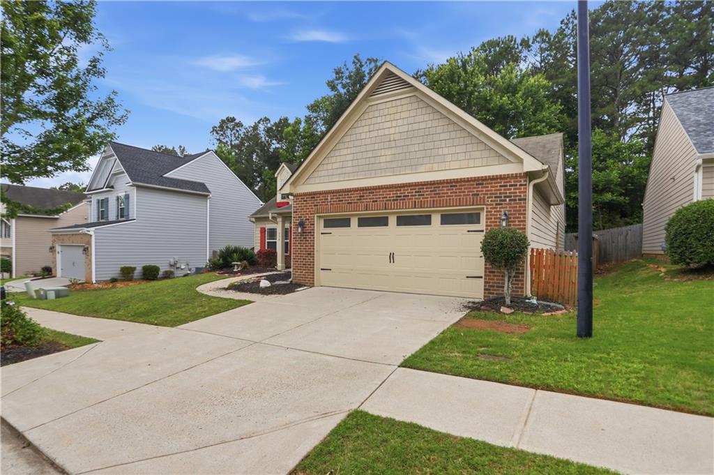 236 Manous Way Canton, GA 30115 - Photo 2 of 25 a view of a white house next to a yard and a large tree