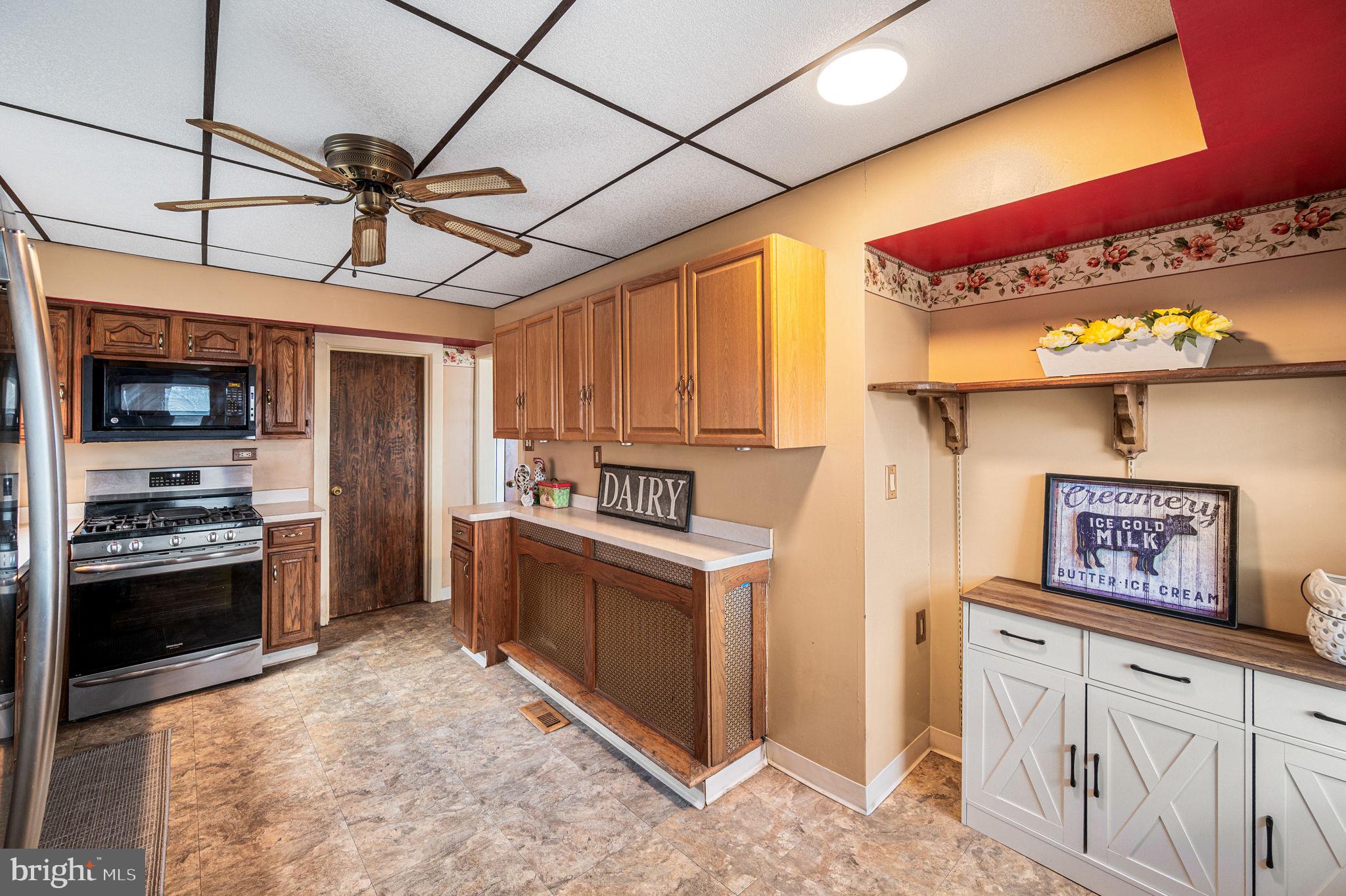 235 Ardmore Avenue Upper Darby, PA 19082 - Photo 12 of 23 a kitchen with stainless steel appliances granite countertop a stove a refrigerator and a sink