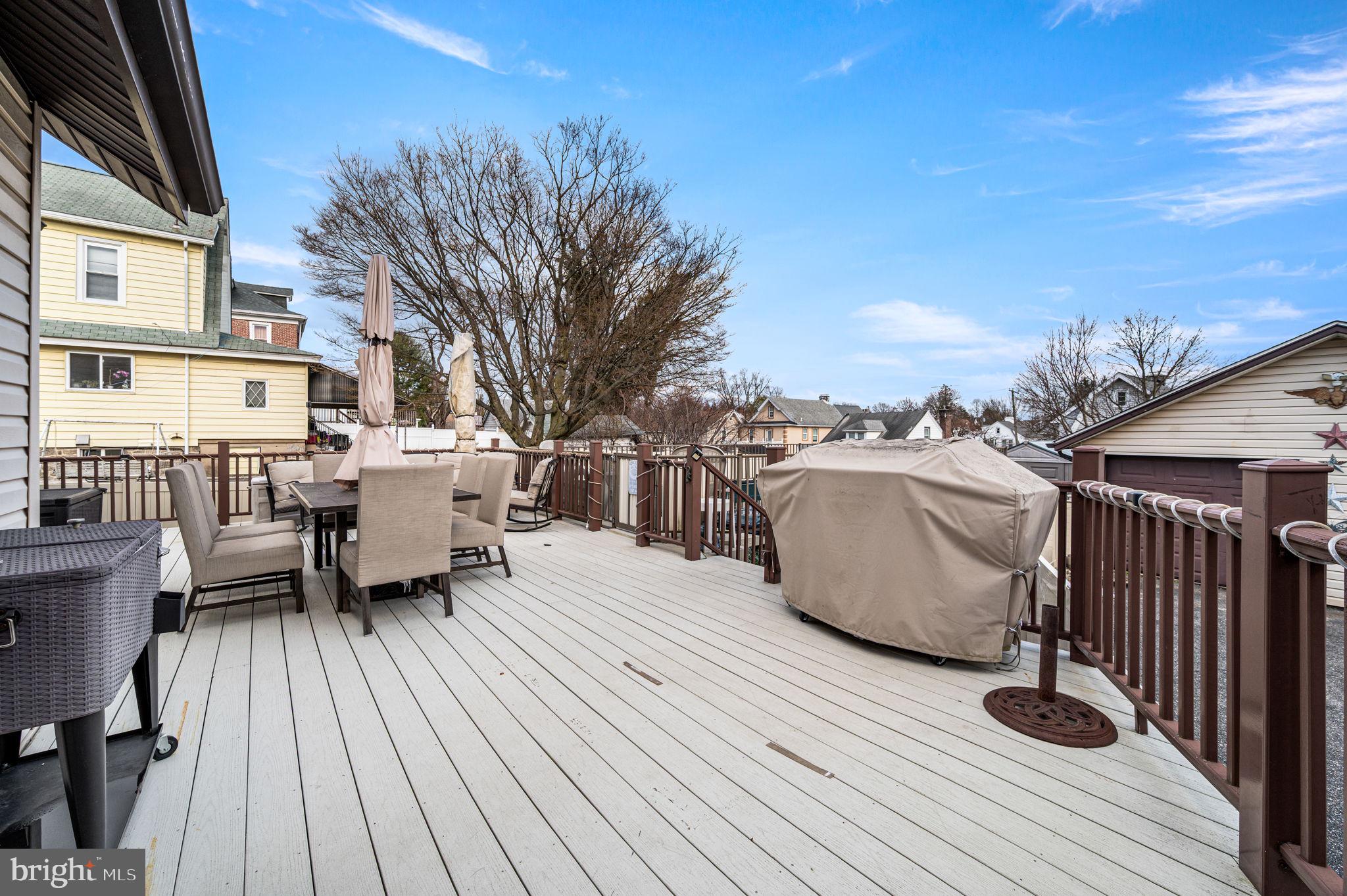 235 Ardmore Avenue Upper Darby, PA 19082 - Photo 17 of 23 a view of a roof deck with table and chairs a barbeque with wooden floor and fence